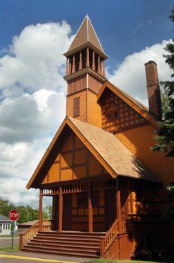 Gold, wooden, painted Church is an example of Victorian Stick Architecture.  First Congregational Church is located in Lake Linden, Michigan on the Upper Peninsula. clipart