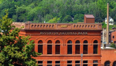 Historic Houghton National Bank sits in downtown Houghton, Michigan.  It is Richardsonian Romanesque style with Jacobsville sandstone on first floor level.   clipart