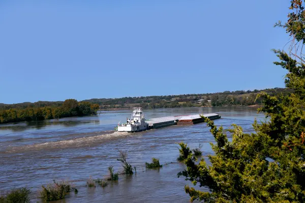 stock image Tugboat transports cargo up the Mississippi River in Arkansas.  It has multiple shipments attached to vessel.