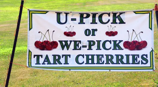 stock image Advertising for a farm that allows you to either buy produce or pick it yourself.  Sign has cherries on it.