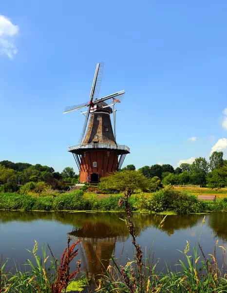 stock image DeZwaan Dutch Windmill, in Holland Michigan is reflected in the calm waters of the Macawa River.