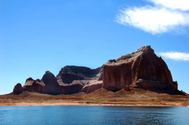 Cliffs of sandstone line the shores of Lake Powell in Utah. clipart