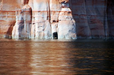 Cave like crevice in the cliff adds interest to a towering wall of sandstone. clipart