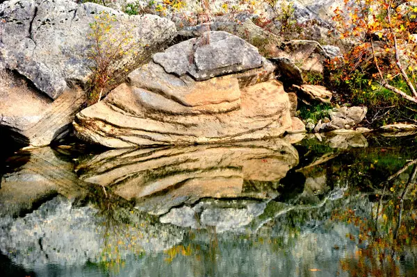 stock image Buffalo River reflects a layered rock on its smooth glassy surface.  Rock is at Buffalo Point at the Buffalo National River State Park in Northern Arkansas.