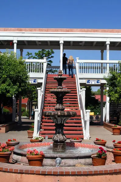 stock image Old Town fountain gurgles gently as tourists climb the picturesque stairs on the plaza.