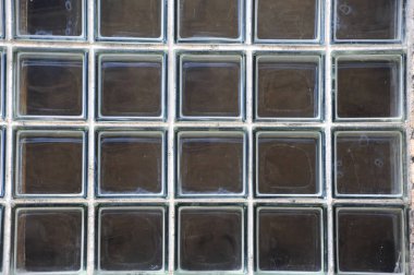 Background image shows large window composed of individual squares of thick glass.  Building is in Stoughton, Wisconsin. clipart