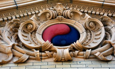 Unusual symbol decorates the exterior of the old Livingston train depot in Montana.  The red and black yin-yang symbol is red and black. clipart