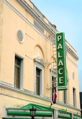 Palace theatre in downtown Hilo, Hawaii is now an arthouse.  This building has a green marque and light tan stucco exterior and was built in 1925. clipart