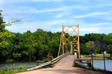 Historic suspension bridge over the White River is a historical landmark.  Located in Beaver, Arkansas just Northwest of Eureka Springs, Arkansas. clipart