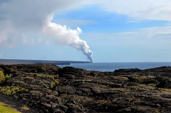 stock image Fumes and smoke billow skyward as Kilauea dumps lava into the ocean on the coast of the Big Island of Hawaii.