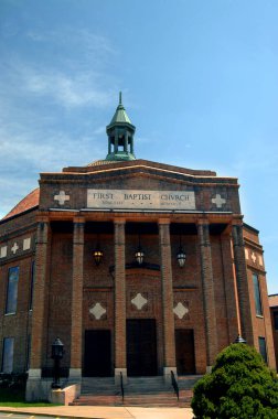 Görüntü, Kuzey Carolina, Asheville 'deki Birinci Baptist Kilisesi' nin ön girişini gösteriyor. Bakır çan kulesi en üstte oturur..