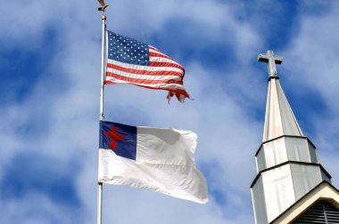 American flag and Christian flag fly besides a church steeple.  Cross seems to stand between or besides the two. clipart