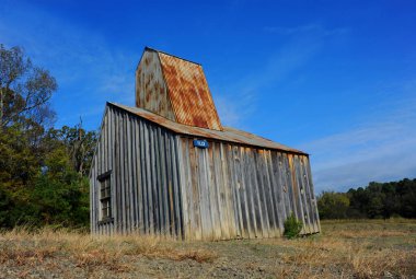 Historic Ozard Diamond Mine Shaft House sits on the field at the Crater of Diamonds State Park in Arkansas. clipart