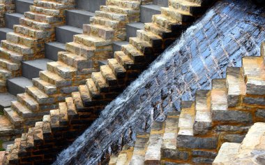 Side view of dam and waterfall in the Bays Mountain State Park, shows overflow sliding down from Bays Mountain lake and reservoir. clipart