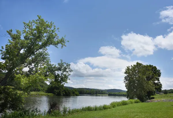 Surgoinsville River Front Park, Holston Nehri kıyısından geçiyor. Güneşli yaz günü mavi gökyüzü ve bulutlar sunar.