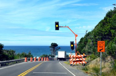 Kamyon, Oregan Sahili boyunca 101. Otoyol 'dan geçerken geçici trafik ışığından geçiyor. İnşaat trafiği yavaşlattı.