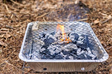 Yanan Kömürlü ucuz alüminyum kullan-at ızgara. Yandan bak. Yüksek kalite fotoğraf