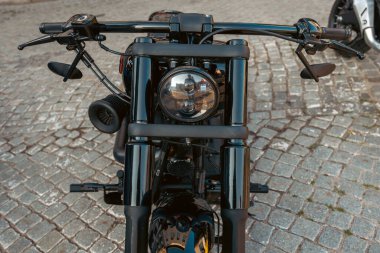 Siyah motosikletin farı yakın plan. Modaya uygun, siyah motosiklet manzaralı. Ağır, güçlü bir motosiklet. Yüksek kalite fotoğraf