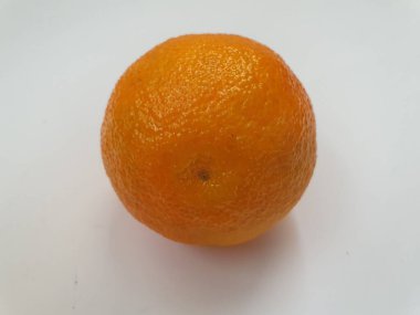 Güzel portakal olgun mandalinalar beyaz bir yüzeyde uzanıyor, lezzetli aromatik bir meyve.