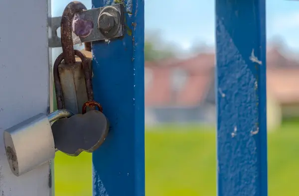 Lock in a gate.Rusty Valentine\'s Day padlocks fastened on the bridge railing.Rusty padlocks, whose locks are supposed to \