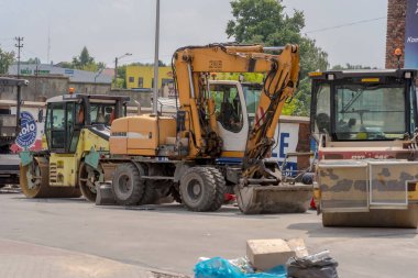  Poland Ostrowiec Swietokrzyski July 11, 2024 11:12 am Liebherr excavator, Ammann and Dynapac road rollers Construction (road) machines stand in a row 