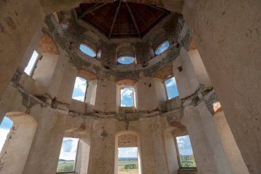  The Krzyz Topor castle - through the tower windows, a summer blue sky is visible, and in the distance, the Holy Cross Mountains . A beautiful and unique castle from the seventeenth century . clipart