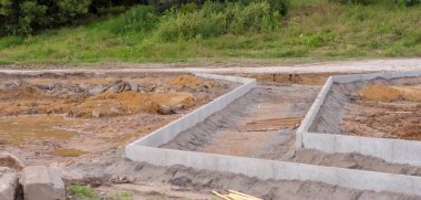 Bir binanın temeli. Şehrin karayolu sisteminin büyük bir yenileme çalışması kapsamında yeni bir kaldırım inşa ediliyor. Kentteki yeni yolda yeni inşa edilen kaldırımın hazır kaldırımları (kenarları).