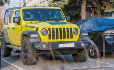  Poland Ostrowiec Swietokrzyski November 16, 2024 2:33 p. m. JEEP WRANGLER RUBICON on a paved parking lot in the city. A variant of the car - an iconic brand of recognized off-road cars - factory-adapted to overcome quite extreme off-road conditions  clipart