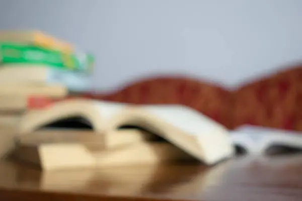 stock image Blurry background book on table and red sofa with white wall in living room