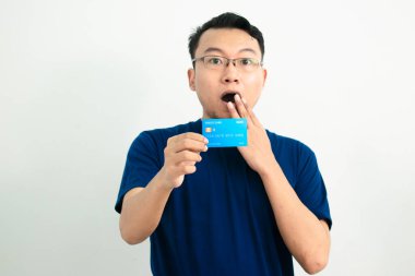 Asyalı adamın kredi kartını göstermesine şaşırdım. Bankacılık, finansal izole, mavi renk konsepti