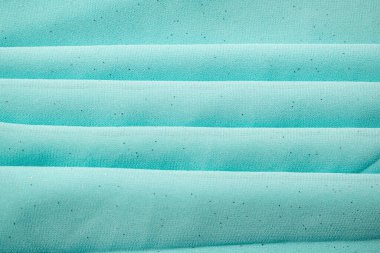 Katlanmış Turkuaz dalgalı buruşuk kumaş biraz köpüklü toz, doku ve arka plan.
