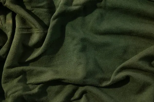 Yeşil ordu kumaşı dalgalı buruşuk arka plan dokusu.