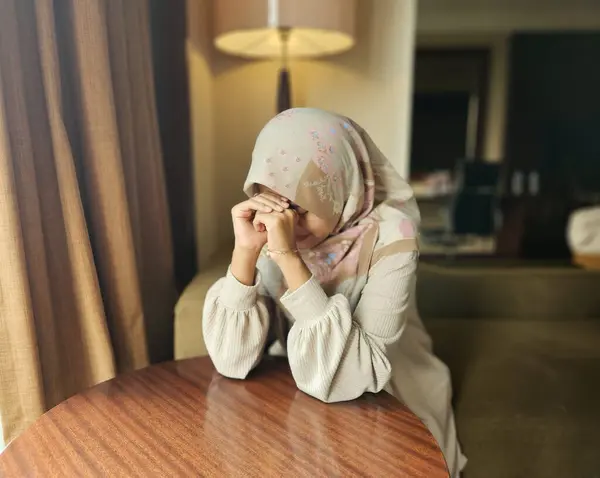 Asyalı Müslüman kadın tesettür takıyor, kötü bir ruh hali içinde, yorgun sıkılmış bir ifade, bulanık bir geçmişi var.