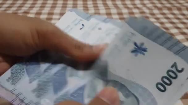 루피아 지폐의 스택을 계산하는 사람의 클로즈업 현금을 사업가 부패의 — 비디오