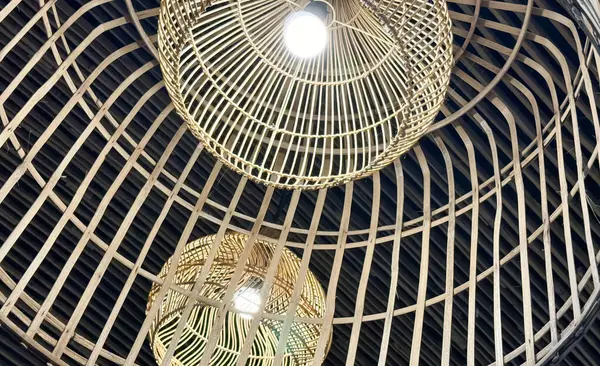 Several modern rattan ceiling lamps hanging in clusters from the ceiling, providing ambient lighting to the room. The lamps feature a sleek and stylish design, adding a contemporary touch to the space