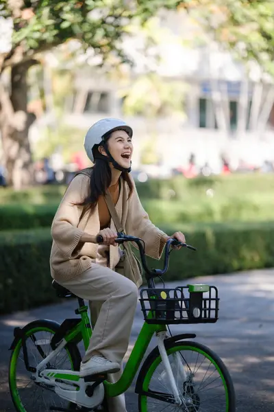 Asian businesswoman go to work at office stand and smiling wear backpack with bicycle. Bike commuting, Commute on bike, Business commuter concept. High quality photo