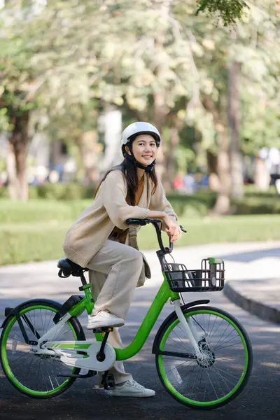 Asian businesswoman go to work at office stand and smiling wear backpack with bicycle. Bike commuting, Commute on bike, Business commuter concept. High quality photo