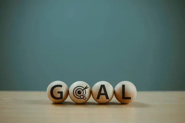 Goal aim target concept. Goal setting planning focus for future. Hand push target board on wooden cube block icon for creative set up business success objective. Achievement winner business project