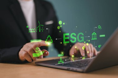 ESG çevre sosyal yönetim kavramı. Adam bilgisayar kullanarak ESG simgesini analiz ediyor. Yeşil çevre işletme finans stratejisi kavramı. ECO şirket raporu, sürdürülebilir iş yatırımı