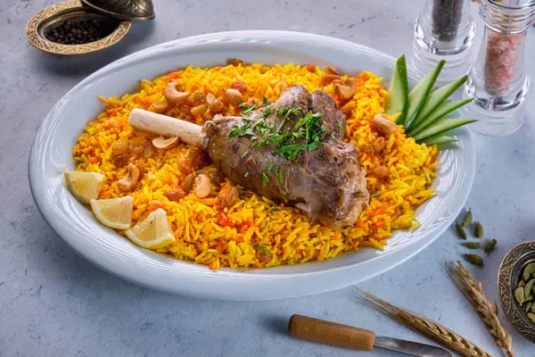 A plate of mandi rice with grilled lamb