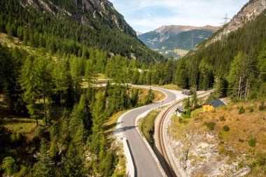 Paved yolu ve İsviçre 'de dağlara giden bir tren yolu.