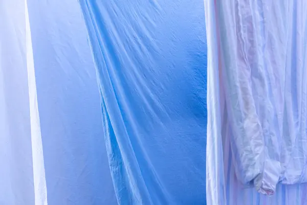 Bed sheets hanging on a washing line