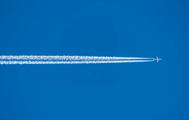 Gökyüzünde beyaz patikalı bir uçak.