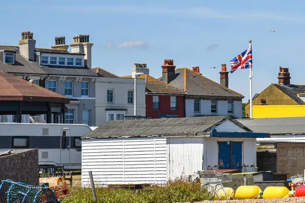 stock image White Wooden Beach Huts with British Flag in England