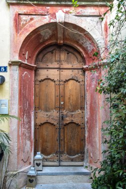 Soluk kırmızı kemerli antik ahşap kapı Courtya ile çevrili.