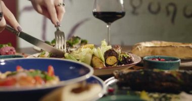 Doğu salatası yiyen kadınların ellerini kapatın. Gürcistan ulusal mutfağı, restoranda masada yemek. Doğu yemekleri. Orijinal geleneksel yemekler. Yüksek kalite 4k görüntü