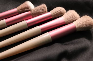 Beyaz ahşap arka planda farklı makyaj fırçaları. Profesyonel makyaj sanatçısı makyaj fırçaları -.