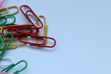 Beyaz arkaplanda renkli ataçlar