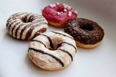 Beyaz Yüzey Şekerleme Arkaplanında Çikolata ve Pembe Cilalı Dört Renkli Donut Görünümü