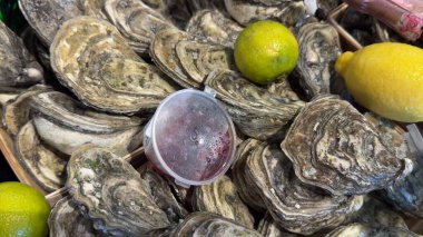 Limon ve soslu taze istiridye. Balık pazarında lezzetli deniz ürünleri ya da güzel bir akşam yemeği sunumu.